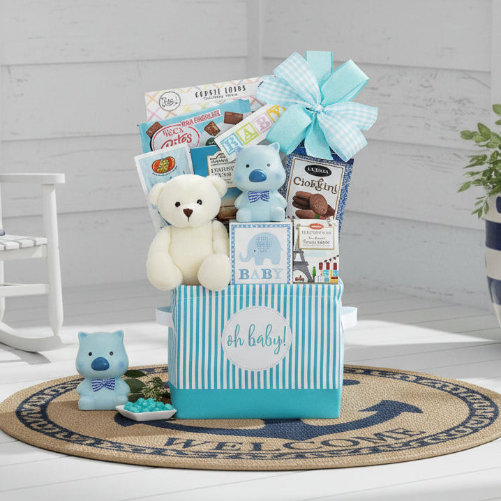 Gift basket for a baby with toys and snacks on a wooden surface.