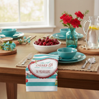 Table setting with cherry-themed decor and a personalized napkin holder.