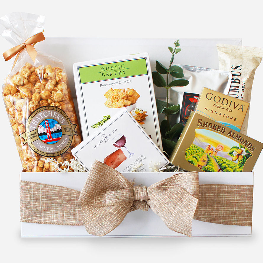 Gift box with snacks and Godiva chocolate on a white background